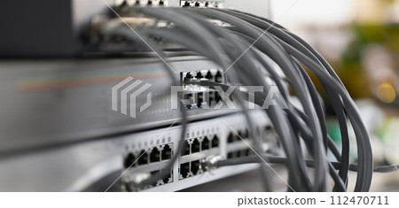 Optical mains cables connected to main server closeup 112470711