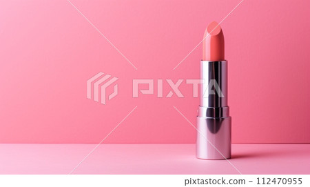 Elegant Silver Lipstick Container on Vibrant Pink Background with Deep Pink Shiny Lipstick 112470955