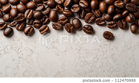 Pile of Freshly Roasted Dark Coffee Beans on a Clean White Surface Pile of Freshly Roasted Dark Coffee Beans on a Clean White Surface 112470998