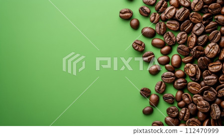 Dark Roasted Coffee Beans Scattered on Green Surface, Perfect for Coffee Shops and Cafes 112470999