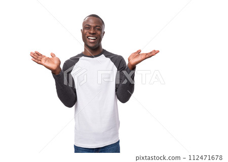 young positive african man dressed in a spring jacket tells interesting news and points with his young positive african man dressed in a spring jacket tells interesting news and points with his 112471678