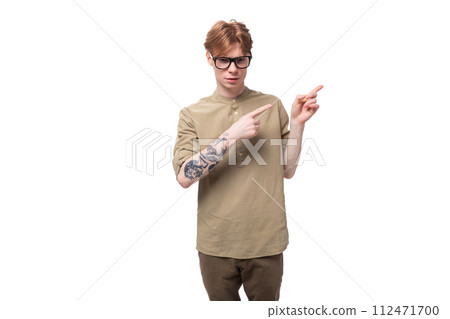 portrait of a charming young european guy with red hair dressed in a trendy brown shirt with short portrait of a charming young european guy with red hair dressed in a trendy brown shirt with short 112471700