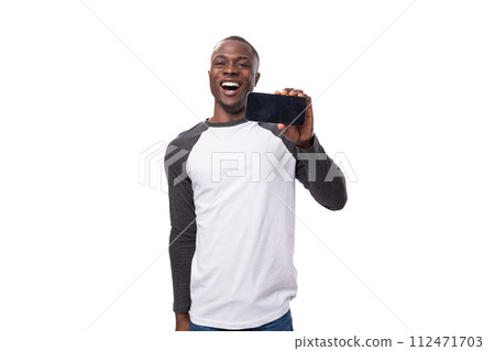 young american guy with short haircut dressed in a long-sleeve sweater reports the news pointing young american guy with short haircut dressed in a long-sleeve sweater reports the news pointing 112471703