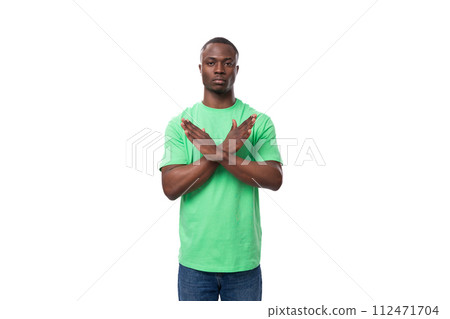 young smart american guy promoter dressed in a mint t-shirt crossed his arms in front of him on a young smart american guy promoter dressed in a mint t-shirt crossed his arms in front of him on a 112471704