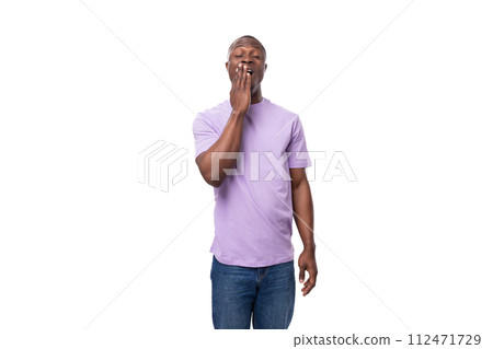 young smart african man dressed in a lilac t-shirt and jeans thinking on a white background young smart african man dressed in a lilac t-shirt and jeans thinking on a white background 112471729