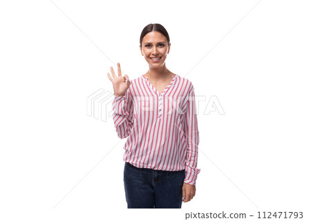 a young smiling European woman with black hair gathered in a ponytail is dressed in a red and white 112471793