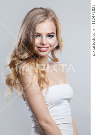 Cheerful young fashion woman with healthy blonde hair and make-up on white background Cheerful young fashion woman with healthy blonde hair and make-up on white background 112471825