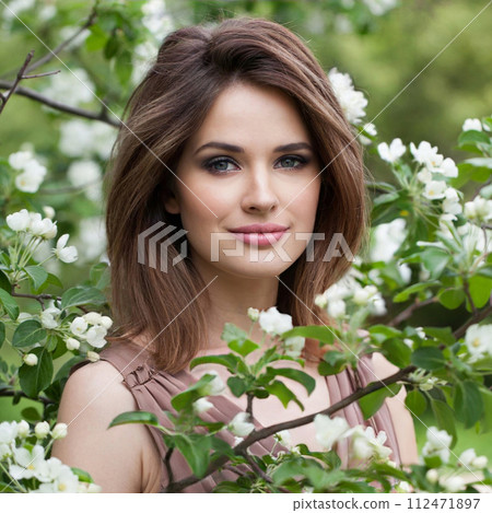 Fashionable brunette lady outdoor portrait. Healthy woman against green blossom background 112471897