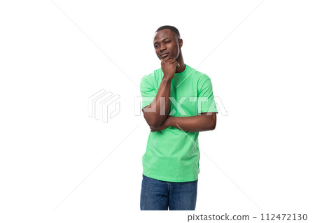 young smart american male advertiser dressed in green t-shirt with mockup thoughtful young smart american male advertiser dressed in green t-shirt with mockup thoughtful 112472130