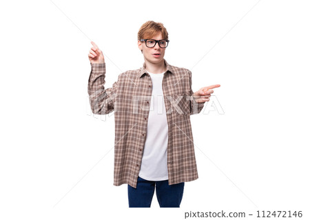 young European man with red hair in glasses and a plaid shirt shows his hands in different young European man with red hair in glasses and a plaid shirt shows his hands in different 112472146
