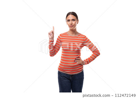 Young smart slim brunette woman dressed in a striped orange blouse and jeans on a white background Young smart slim brunette woman dressed in a striped orange blouse and jeans on a white background 112472149