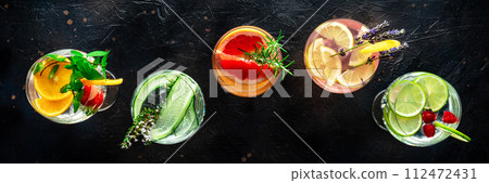 Fancy cocktails with fresh fruit. Gin and tonic drinks with ice at a party Fancy cocktails with fresh fruit. Gin and tonic drinks with ice at a party 112472431