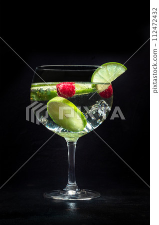 Fancy cocktail with fresh fruit. Gin and tonic drink with ice at a party 112472432