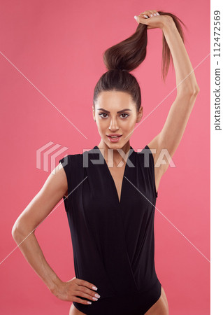 Beauty model girl holds in hands brown straight long hair. Portrait of woman with beautiful long hair. Care and hair products. Beauty model girl holds in hands brown straight long hair. Portrait of woman with beautiful long hair. Care and hair products. 112472569