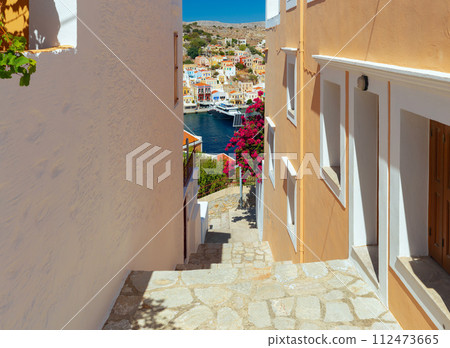 Old narrow traditional street in the Greek village of Symi. 112473665