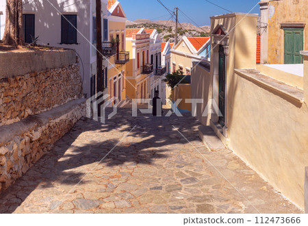 Old narrow traditional street in the Greek village of Symi. 112473666