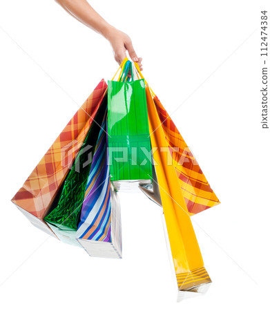 Female hand holding shopping bags 112474384