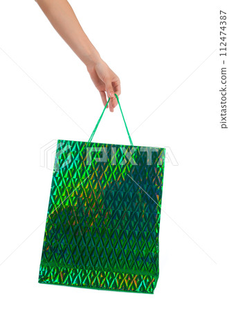 Female hand holding shopping bags 112474387