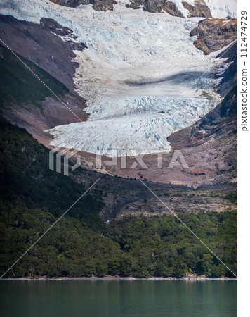 Majestic Glacier Streaming Down to a Serene Lake 112474729