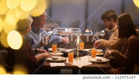 A modern and traditional European Islamic family comes together for iftar in a contemporary restaurant during the Ramadan fasting period, embodying cultural harmony and familial unity amidst a A modern and traditional European Islamic family comes together for iftar in a contemporary restaurant during the Ramadan fasting period, embodying cultural harmony and familial unity amidst a 112475147