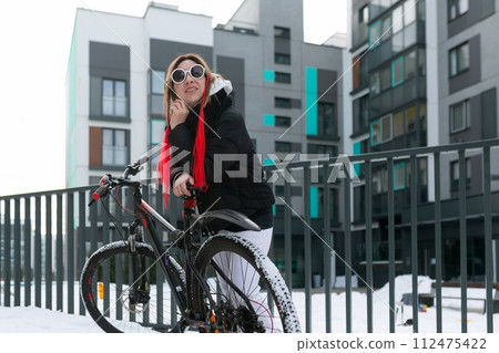 European woman in winter clothes spends time walking outdoors European woman in winter clothes spends time walking outdoors 112475422