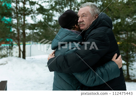 Happy elderly couple walking in the park and confessing their feelings Happy elderly couple walking in the park and confessing their feelings 112475443