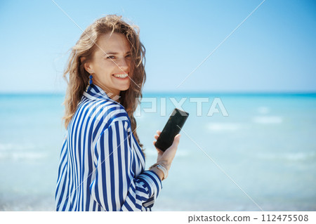 happy elegant woman on ocean coast 112475508