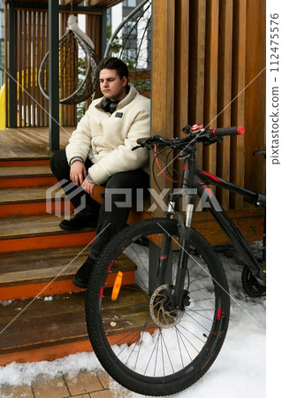 Lifestyle concept, young man stopped while cycling Lifestyle concept, young man stopped while cycling 112475576