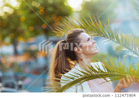 smiling 40 years old woman in dress and jacket in city smiling 40 years old woman in dress and jacket in city 112475904