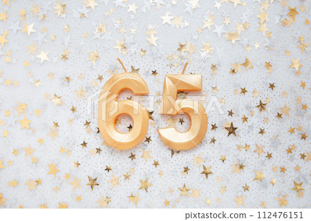 Number 65 sixty five golden celebration birthday candle on Festive Background. sixty five years birthday. concept of celebrating birthday, anniversary, important date, holiday 112476151