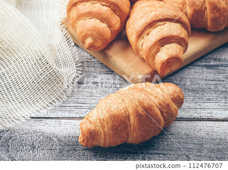 Freshly baked golden brown Tasty baked croissants, warm buttery croissants, breakfast concept Freshly baked golden brown Tasty baked croissants, warm buttery croissants, breakfast concept 112476707