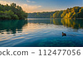 A serene blue lake shimmers 112477056
