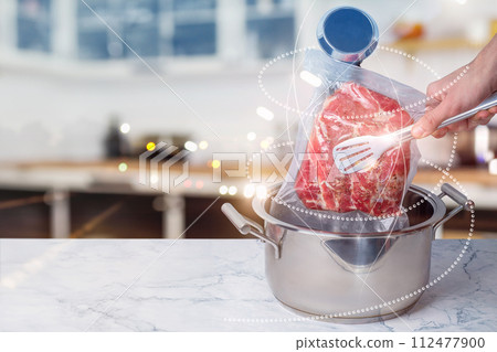 The concept of cooking vacuum packed meat. 112477900