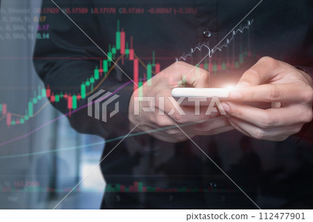 Trader performing analysis with a mobile device . 112477901