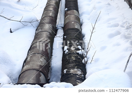 The main provides the city with hot water. Selective focus. The pipes of the central heating system 112477906