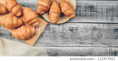 Freshly baked golden brown French croissants. Tasty baked croissants, warm buttery croissants, breakfast concept 112477921
