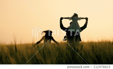 silhouette father mother child girl daughter sitting shoulders, happy family running into sunset, agriculture, wheat field sunset, happy family with child daughter running through wheat field sunset silhouette father mother child girl daughter sitting shoulders, happy family running into sunset, agriculture, wheat field sunset, happy family with child daughter running through wheat field sunset 112478023