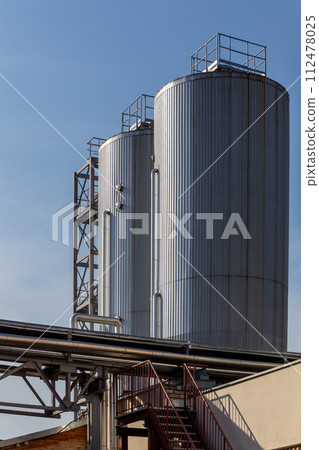 Brewery silos or tanks typically use for storing barley or fermented beer. Brewery silos or tanks typically use for storing barley or fermented beer. 112478025