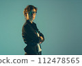 studio photo of a woman with glasses and dark case 112478565