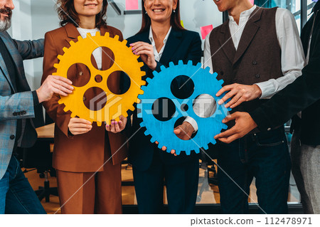 Business team work together and combine pieces of gears. Partnership and integration concept Business team work together and combine pieces of gears. Partnership and integration concept 112478971