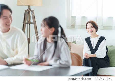 Mother watching over girl studying 112479069