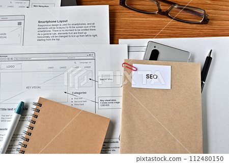 A desk with a card that says SEO 112480150