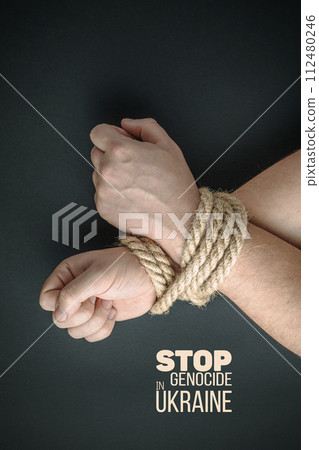 tightly tied hands with thick rope 112480246