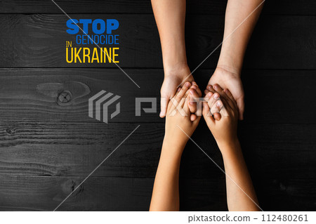 childrens hands holding each other dark background 112480261