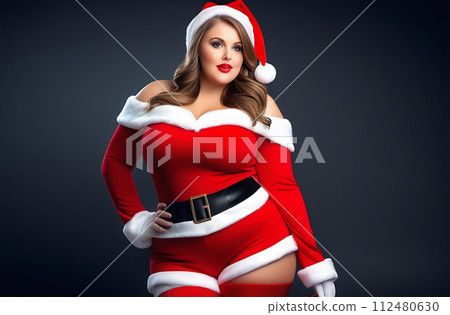 The model is a plump young woman in the role of Santa Claus on the occasion of Christmas, in a sexy outfit, she smiles and looks at the camera 112480630