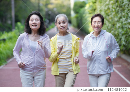 Three senior women walking Three senior women walking 112481022