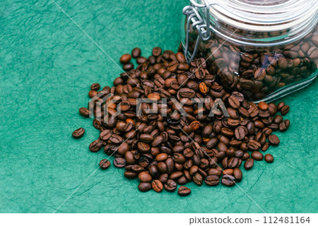 Coffee beans and glass bottle green background d-2-1 112481164