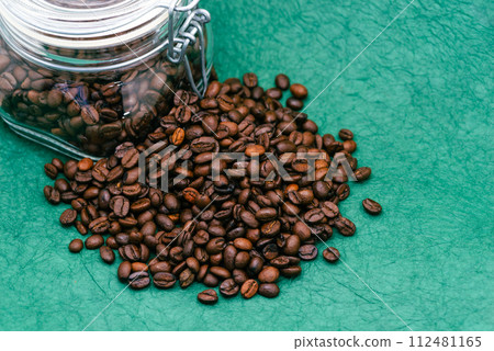 Coffee beans and glass bottle green background d-2-2 Coffee beans and glass bottle green background d-2-2 112481165
