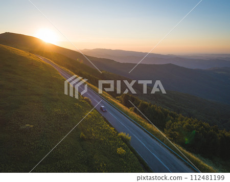 Traveler with car in the mountain road at sunset 112481199