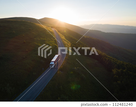 Delivery company is driving on forest road in the mountains 112481240